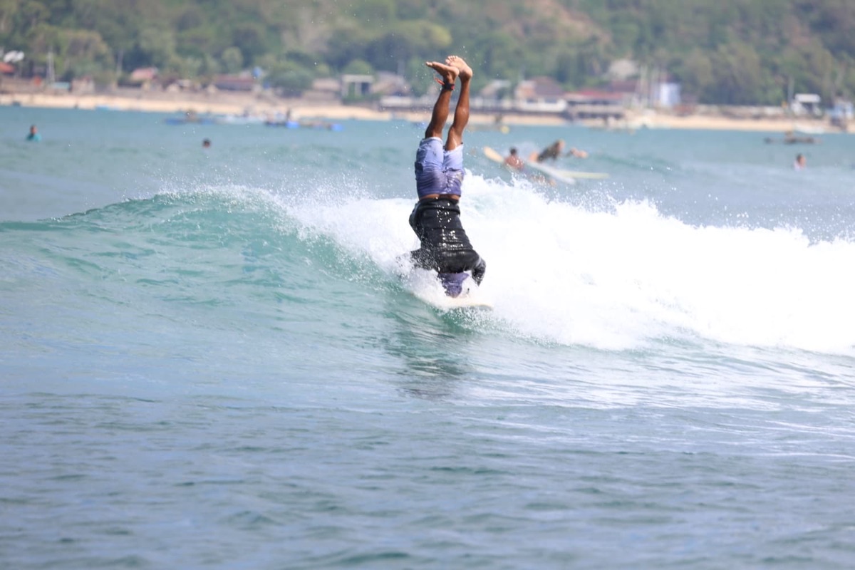 A surfer riding a wave across the bay