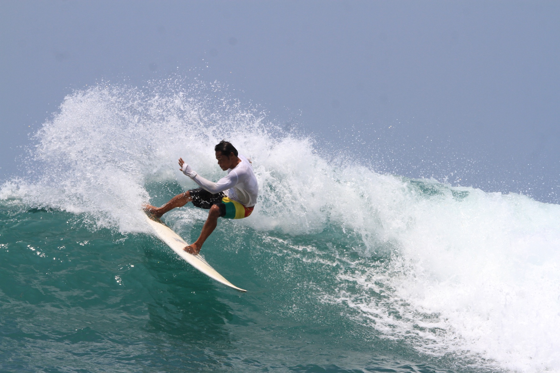 A surfer riding a wave in Gerupuk