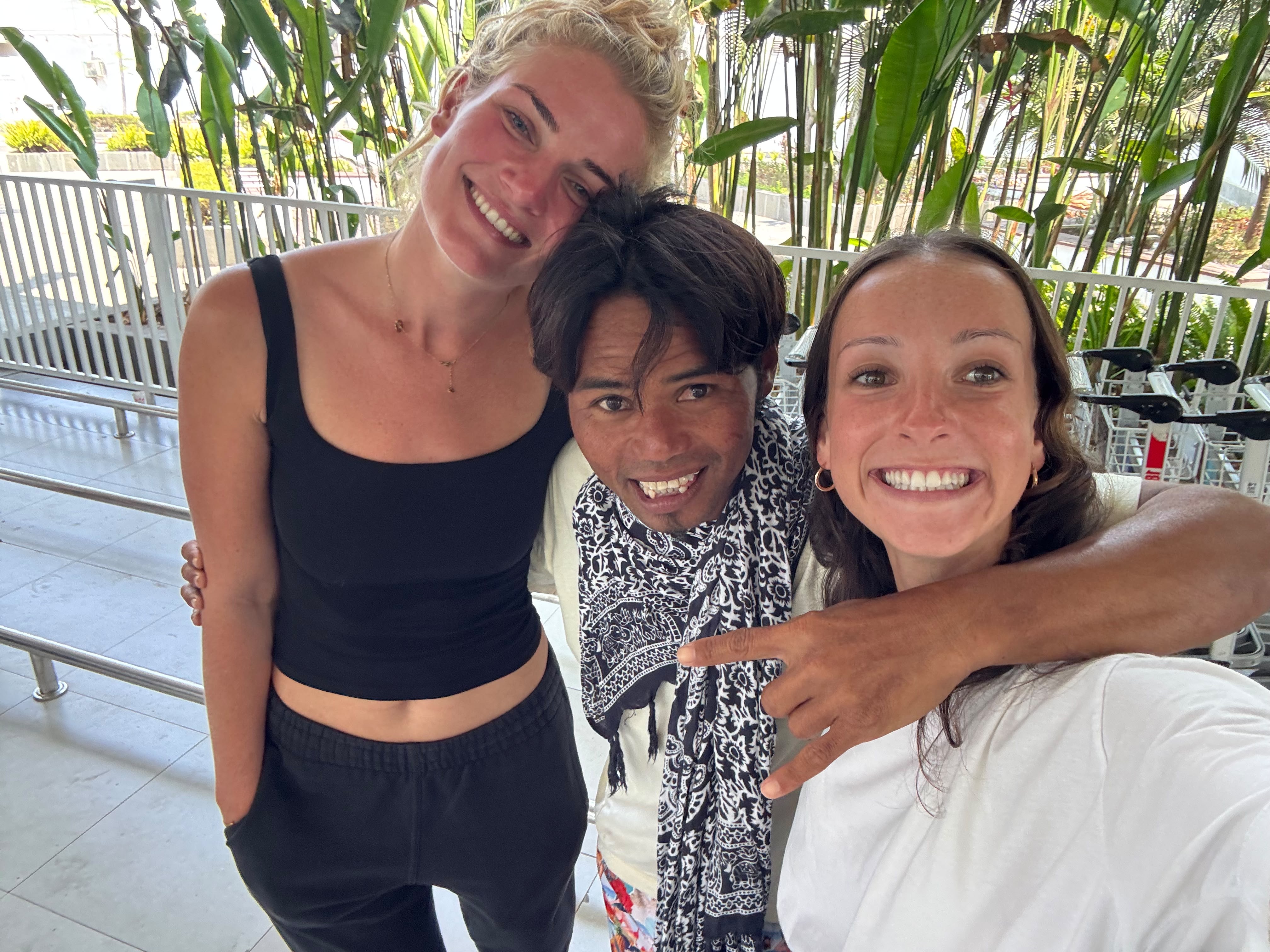 Dedy smiling with two guests