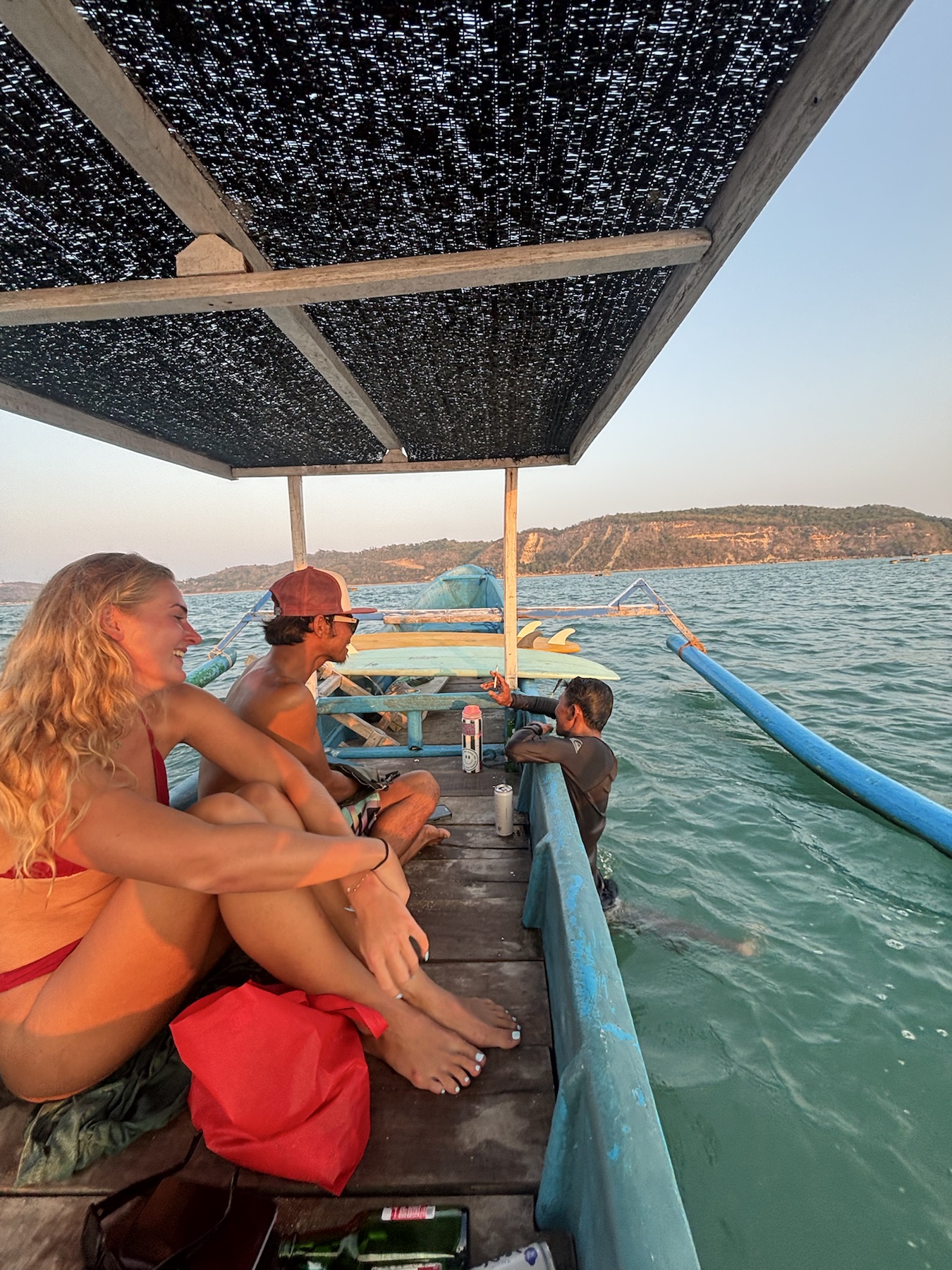 Surfers on a boat crossing the bay